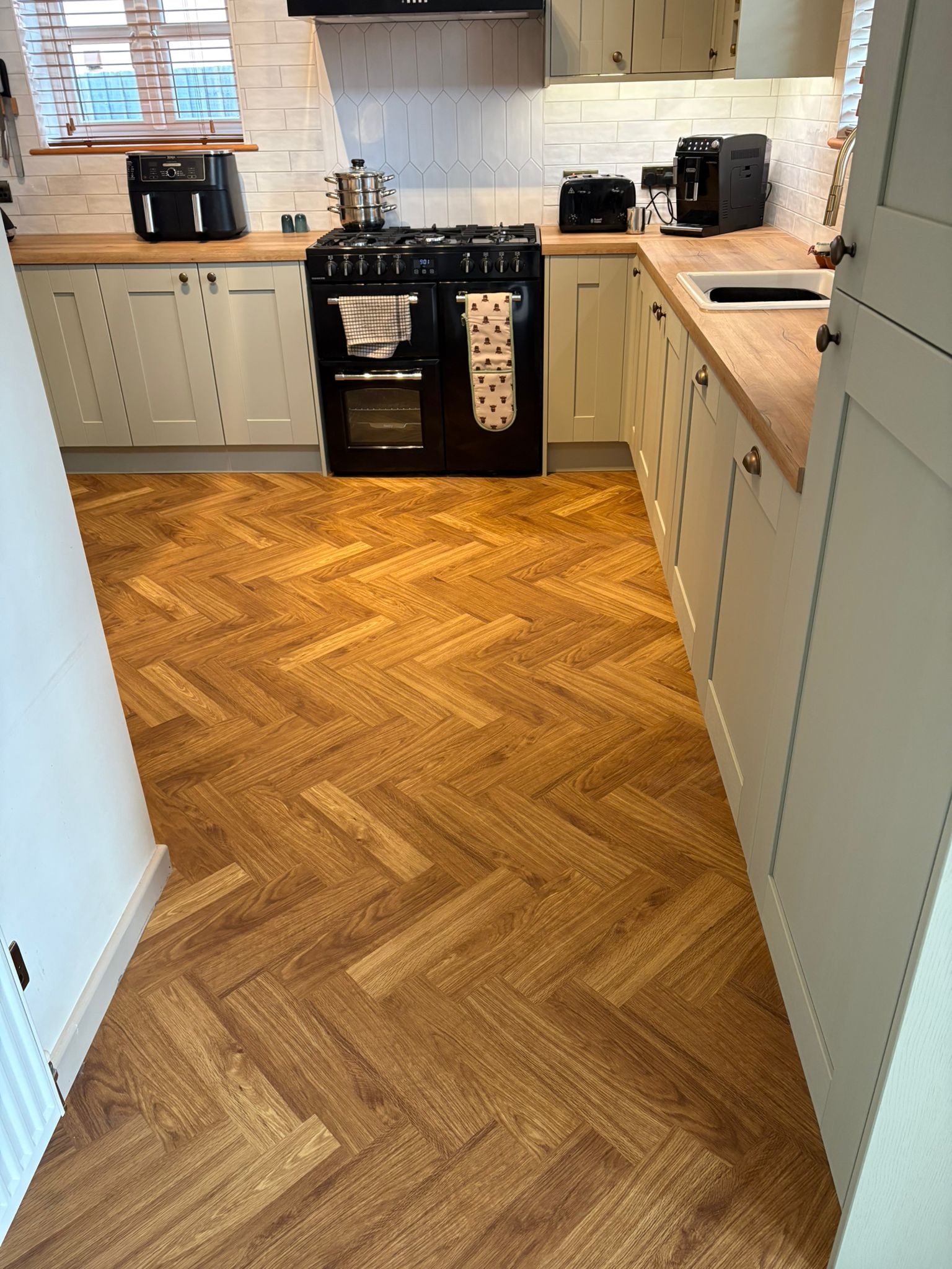 Oak herringbone LVT professionally fitted in a kitchen by Affordable Floors 2 You